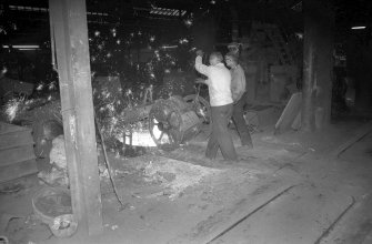 Interior
View showing men filling large ladle