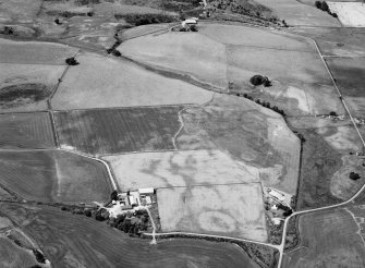 Oblique aerial view centred on cropmarks of geomorphological origin with the site of St Luke's Chapel and well at Clova adjacent, looking to the WNW.