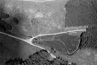 Oblique aerial view centred on the remains of the henge at Wormy Hillock, looking to the NE.