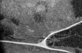 Oblique aerial view centred on the remains of the henge at Wormy Hillock, looking to the NNE.