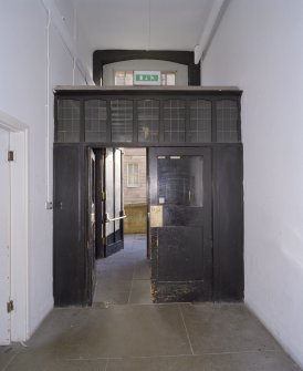 Interior.  Basement, corridor, doorway at E end, view from W