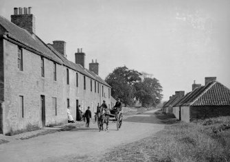 View of West Saltoun Main Street with horse and cart and people.