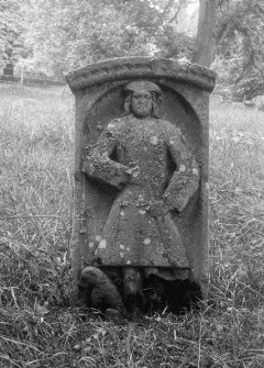 View of carved tombstone with portrait of man.