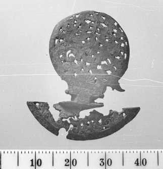 Engraved copper-alloy cock-foot from a pocket-watch. Scale in millimetres.