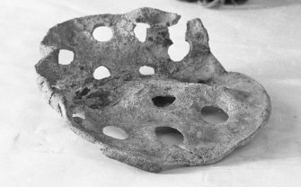 Perforated lead disc from the wreck-site, probably part of a pump filter. 200 mm in diameter and 3 mm thick, pierced by 19 holes.