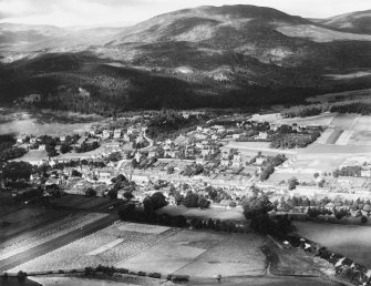 Kingussie and Creag Bheag.  Oblique aerial photograph taken facing north-west.  This image has been produced from a print.