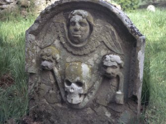 Detail of headstone showing winged angel and skull carried by two lions, Crailing Old Burial Ground