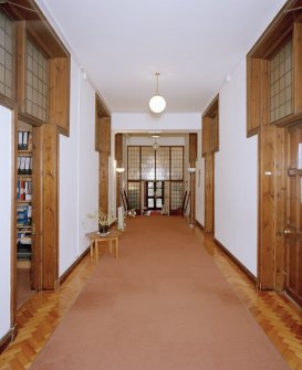 Interior, view of basement corridor from North showing glazed screens