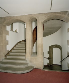 Interior, view of main staircase showing stone arches