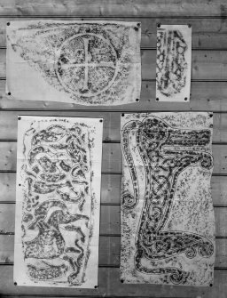 Photographic copy of four rubbings. The lower right rubbing shows central reverse panel of Rodney's Stone Pictish cross slabb, Brodie. The remaining rubbings are unidentified.