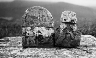 Skye, Kilchrist. Detail of two stones found in the churchyard. On the left, an armorial stone in two pieces; on the right a fragement of a cross-shaft.