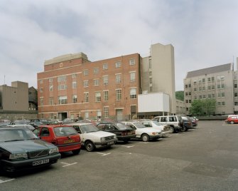 View of 1930's brick building  from ESE