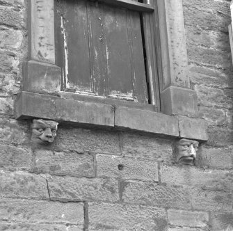 Detail of carved masks on keystones and console brackets