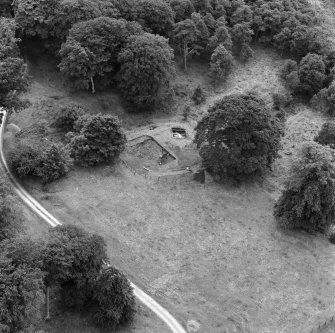 Oblique aerial view from NE showing excavations in progress at Lochmaben Castle.