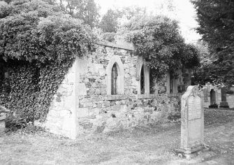 General view of ruined church and churchyard.