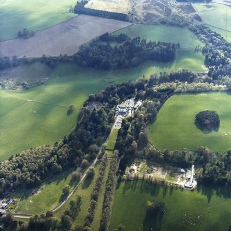 Oblique aerial view centred on the tower-house and hotel with the walled garden adjacent, taken from the ENE.