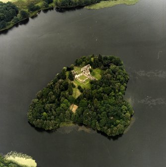 Oblique aerial view centred on the remains of the priory, taken from the SSW.