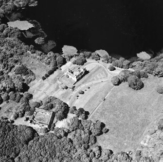 Oblique aerial view from SSE, centred on the tower-house.