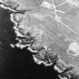 Oblique aerial view centred on the remains of the anti-aircraft battery and buildings, taken from the SE.