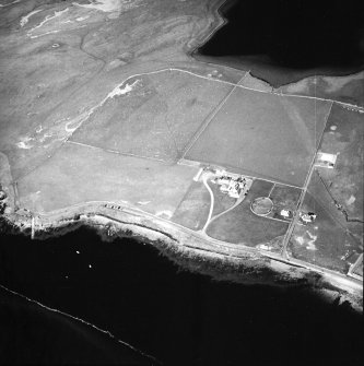 Oblique aerial view centred on the hotel with the remains of the rig adjacent, taken from the S.