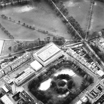 Oblique aerial view centred on the library with George Square, University buildings and Meadows adjacent, taken from the NE.