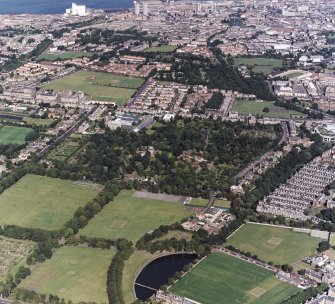 Edinburgh, oblique aerial view, taken from the SSW, centred on the Royal Botanic Gardens and Inverleith House, with the Stockbridge Colonies and the Tanfield headquarters of Standard Life Assurance in the centre right. Powderhall stadium is visible in the top right-hand corner.