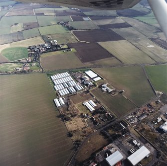 Oblique aerial view centred on the farm, buildings, farmhouse and mushroom farm with farmhouse and buildings adjacent, taken from the WNW.