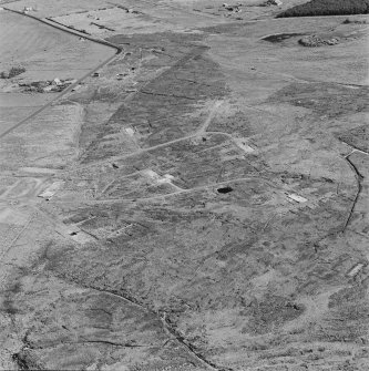 Oblique aerial view of Orkney, Hoy, Lyness, Royal Naval Oil Terminal, view from NW of the hut bases of a military camp to the NW of the Naval Base.  In the background the officers' quarters and the Naval Cemetery.