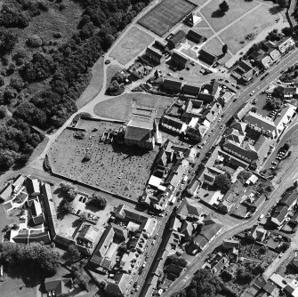 Oblique aerial view of Lesmahagow centred on the church and churchyard, taken from the NNW.