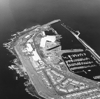 Oblique aerial view centred on the harbour, taken from the SSE.