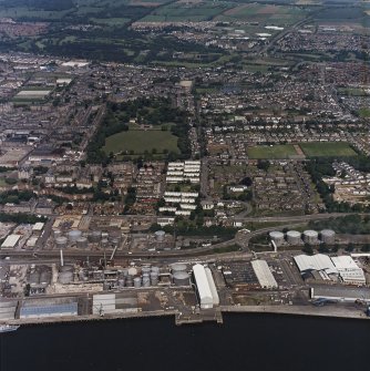 General oblique aerial view of Dundee centred on the park and pavilion with the oil refinery adjacent, taken from the SSE.