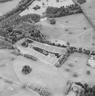Oblique aerial view of Blair Castle centred on the walled garden with the remains of a church adjacent, taken from the NNW.