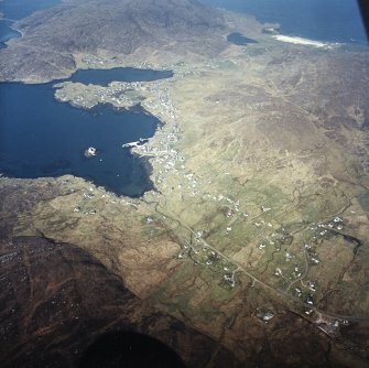 General oblique aerial view of Castlebay, the tower-house and pier, taken from the E.

