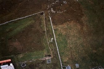 Oblique aerial view centred on the standing stone, taken from the NNW.