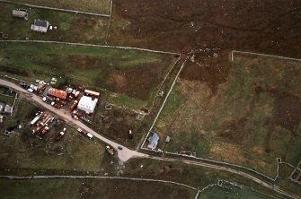 Oblique aerial view centred on the standing stone, taken from the WNW.
