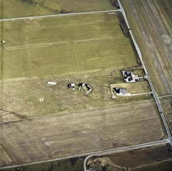 Oblique aerial view centred on the remains of the castle with the remains of the radar station adjacent, taken from the NW.
