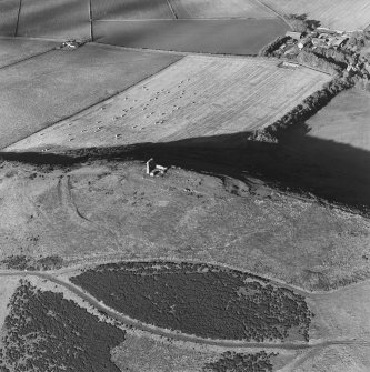Oblique aerial view of Dunnideer centred on the remains of the fort and tower-house, taken from the S.