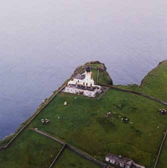 Oblique aerial view centred on the lighthouse with the remains of the dun adjacent, taken from the ENE.
