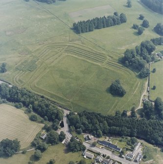 Oblique aerial view centred on the remains of the Roman Fort, chapel and burial ground, with road bridge adjacent, taken from the WSW.