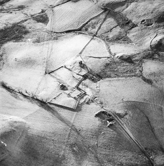 Oblique aerial view centred on the remains of the farmstead, buildings and tower-house, with the remains of the farmstead adjacent, taken from the E.