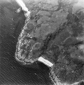 Oblique aerial view centred on the remains of the dun, taken from the SSE.