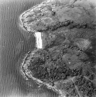Oblique aerial view centred on the remains of the dun, taken from the ESE.