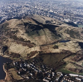 Oblique aerial view of Holyrood Park centred on the remains of cultivation terraces on the slopes of Arthur's Seat with Dunsapie Hill adjacent, taken from the ESE.