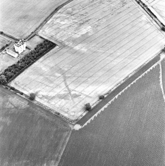 West Mains, oblique aerial view, taken from the WSW, centred on linear cropmarks. Falside Castle is visible in the centre left of the photograph.