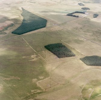 Pennymuir, oblique aerial view, taken from the SW, centred on Roman Temporary Camps, a linear earthwork and an area of rig. The course of 'Dere Street' is visible in the top right half of the photograph.