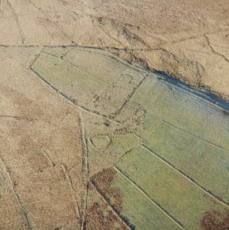 Oblique aerial view of Ettleton Sike centred on the remains of a farmstead, field-system, rig and boundary banks with further boundary banks and rig adjacent, taken from the SE.