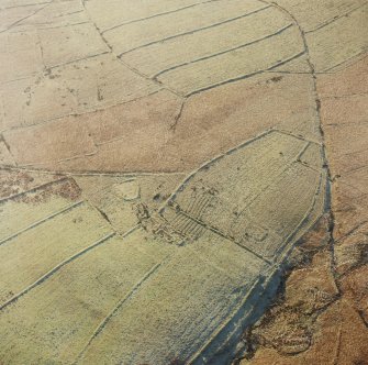 Oblique aerial view of Ettleton Sike centred on the remains of a farmstead, field-system, rig and boundary banks with further boundary banks and rig adjacent, taken from the NE.