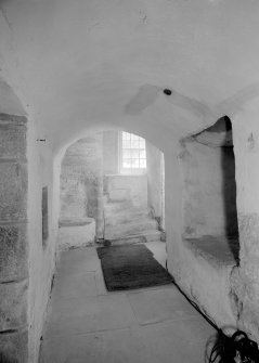 Interior view of Castle Fraser showing view of base of stair and porter's seat.