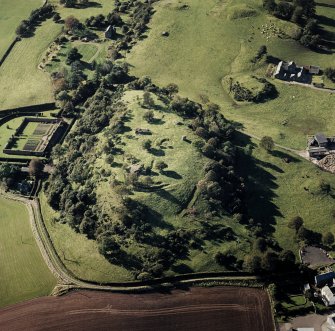Oblique aerial view centred on the remains of the vitrified fort and broch, taken from the ENE.