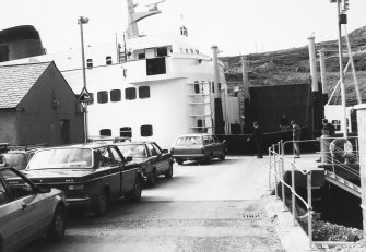 View of cars driving onto ferry.